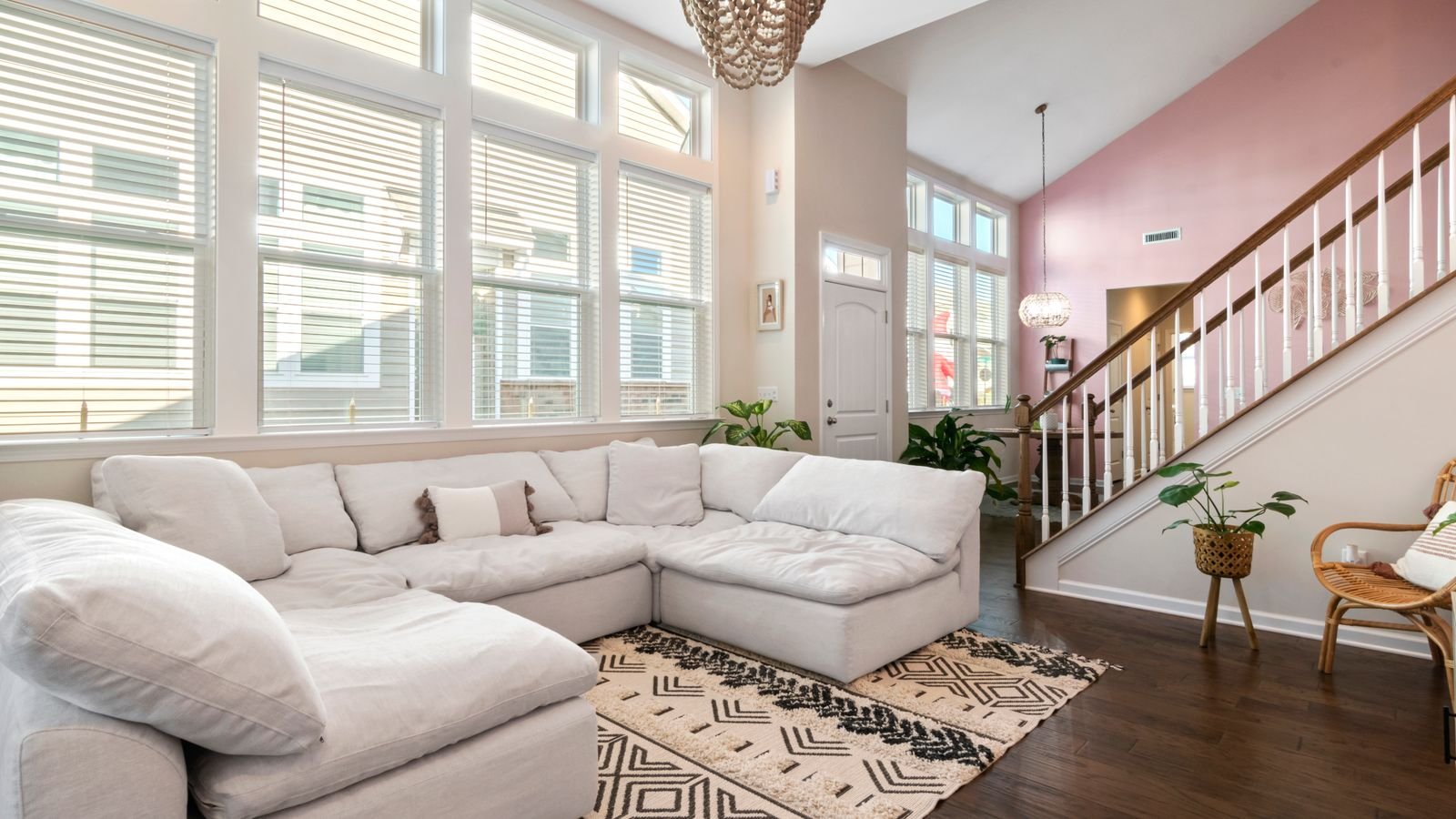 Clean, bright living room with soft neutral furnishings and natural light