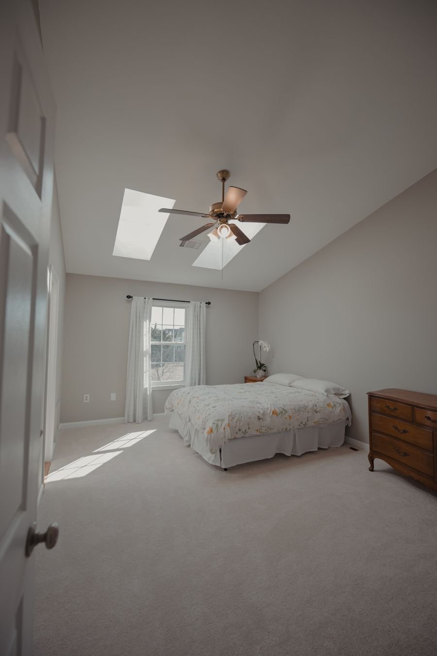 Bright, tidy bedroom with natural light and a made bed